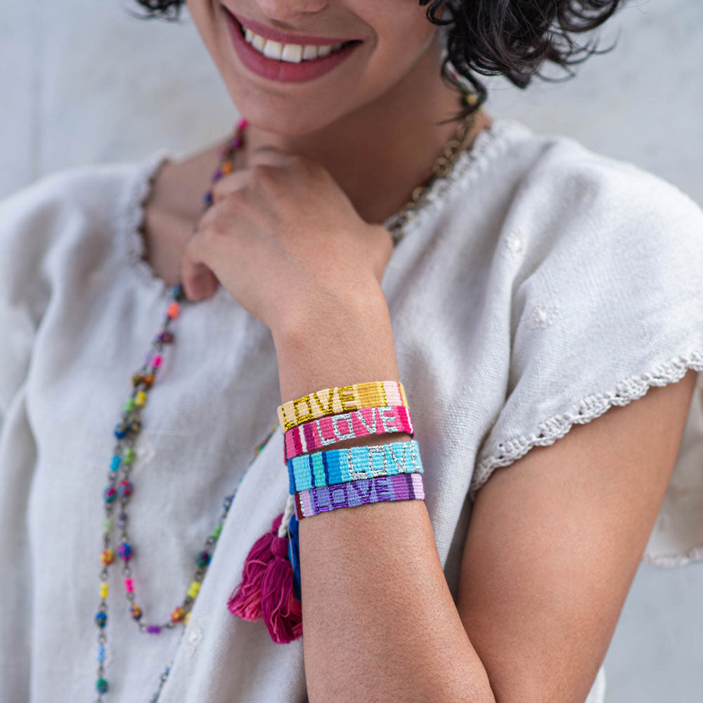 A model wearing a stack of Atitlan LOVE Bracelets from Love Is Project
