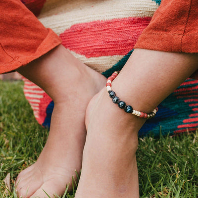 A customer wearing the Achira Harmony LOVE Bracelet as an anklet - Love Is Project