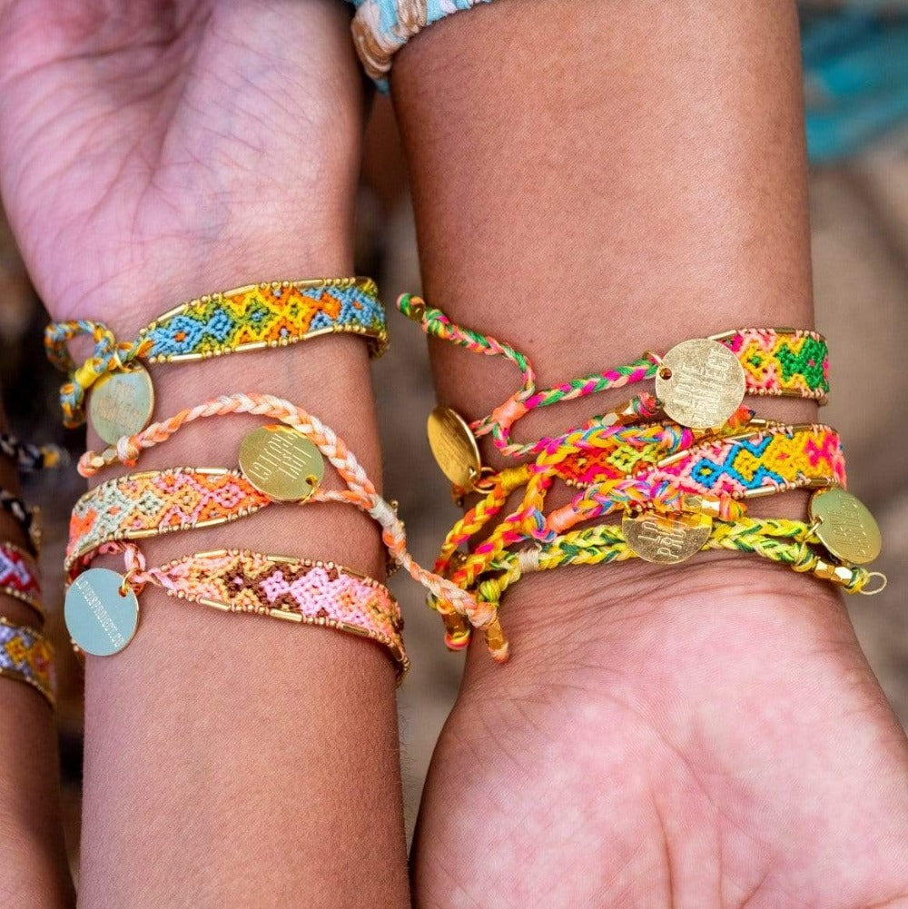 A model wearing the Jungle Bali Friendship Bracelet Bundle from Love Is Project