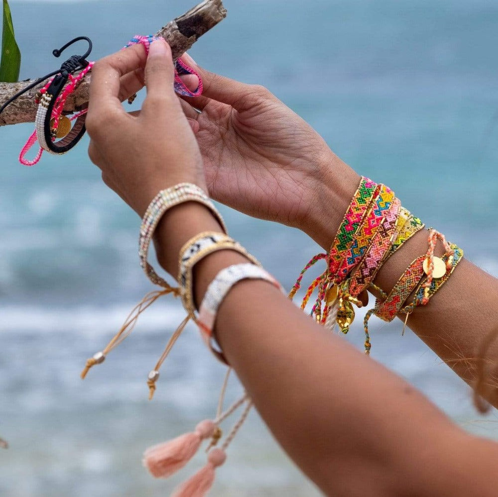 A model wearing the Jungle Bali Friendship Bracelet Bundle from Love Is Project