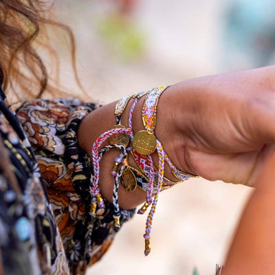 A model wearing the Quartz Bali Friendship Bracelet Bundle from Love Is Project