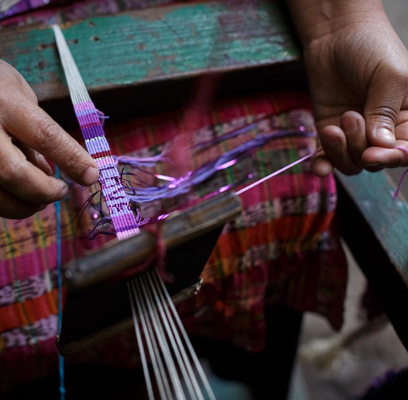 An artisan makes a Purple and Violet Atitlan LOVE Bracelet from Love Is Project