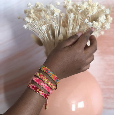 A model wearing the Fire Bali Friendship Bracelet Bundle from Love Is Project