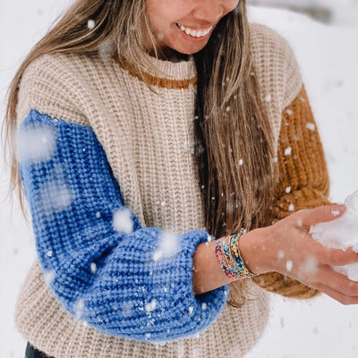 A model in the snow wearing the Coastal Bali Friendship Bundle from Love Is Project